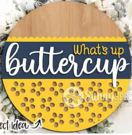 Circular wooden sign with 'What's up buttercup' text and yellow center.